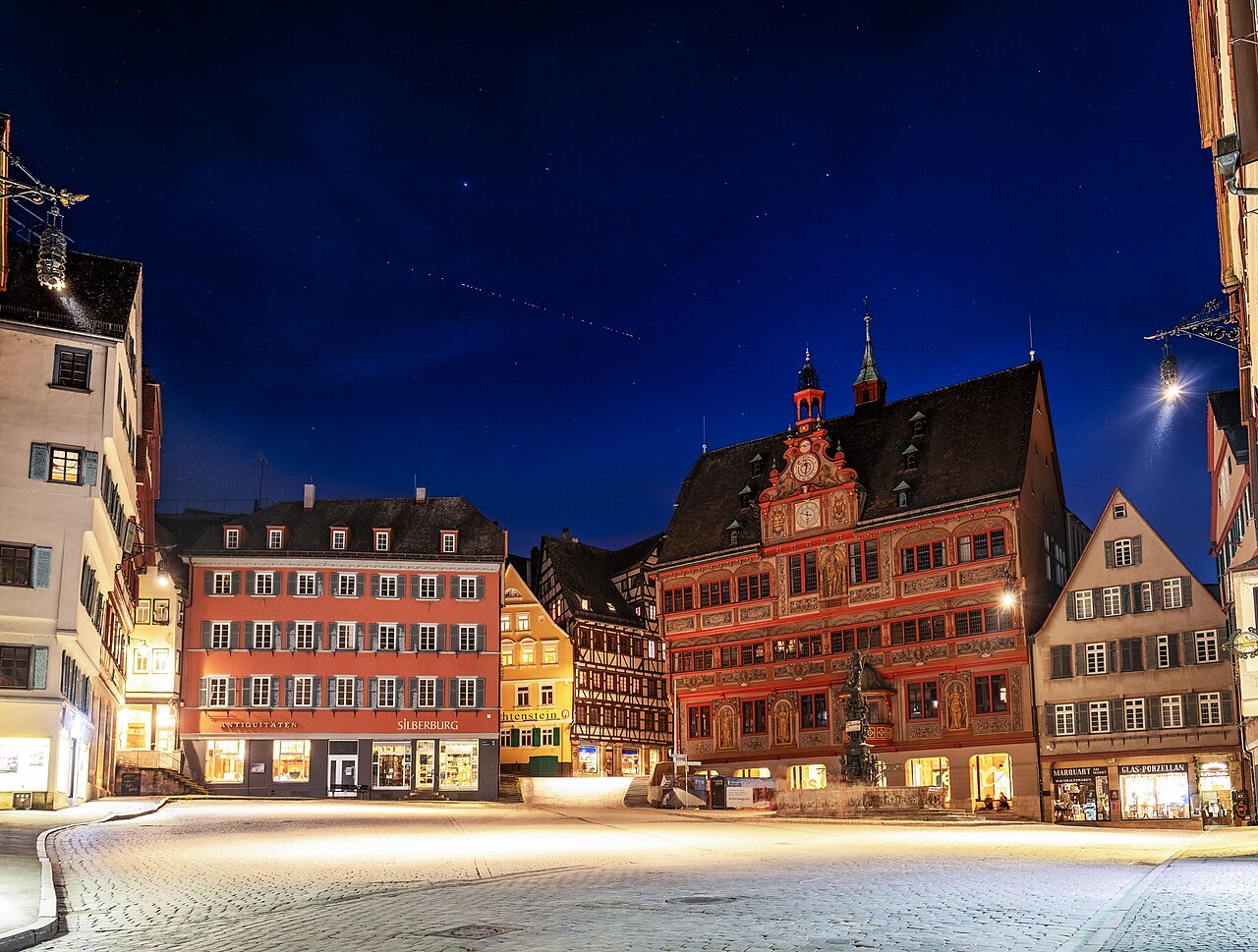 A train of Starlink satellites passing over the town hall in Tuebingen, Germany